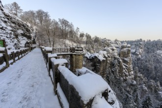 Winter on the Bastei Bridge with a view of the Ferdinandstein and the Wehlgrund, Saxon Switzerland,