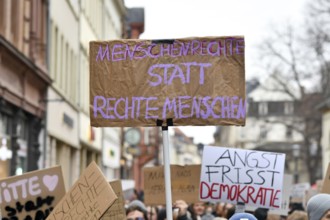 Heidelberg, Germany - February 12th 2025: Person holding up sign with text 'Human rights instead of
