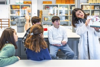 Science teacher engaging high school students with an anatomical model during an interactive