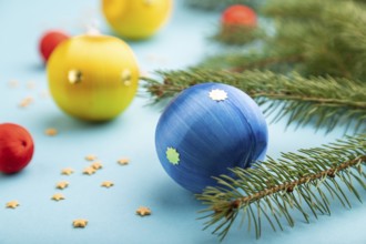 Christmas or New Year composition. Decorations, blue, red, yellow balls, fir and spruce branches,