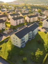 Sunlit apartment blocks with surrounding trees and streets, Calw, Black Forest, Germany
