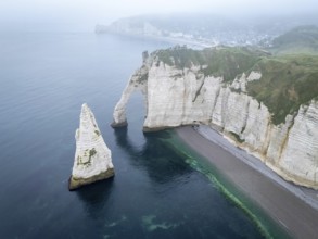 Aerial view of La Porte d'Aval and l'Aiguille on the Alabaster Coast in light fog, Etretat,