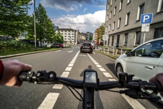 Cycling in the city, city centre road, car blocking cycle lane traffic in both directions, cyclist