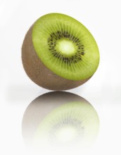 Half a kiwi, kiwi fruit, Chinese gooseberry (Actinidia deliciosa) against a white background,