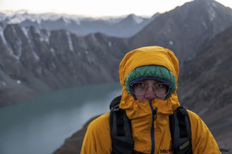 Mountaineer at Ala Köl mountain lake, in the Tien Shan Mountains, near Altyn Arashan, Kyrgyzstan