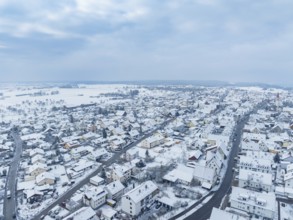 Overview of snow-covered town under cloudy sky, Deckenpfronn, Böblingen district, Germany