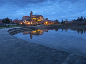 Castle hill with collegiate church St. Servatius with reflection in water basin in the evening,