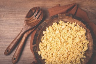 Cooked couscous, in a wooden bowl, top view, no people