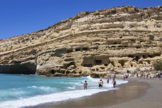 Matala beach with a view of the rock caves, south coast, Crete, Greece