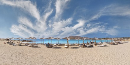 Diakoftis extensive sandy beach with parasols and sun loungers under a clear blue sky, Diakoftis