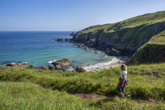 A hiker on a coastal path. View of Rose-an Hale Cove. Between Gurnard's Head and Carnelloe Headland