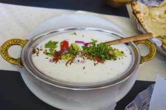 Indian cuisine, Mix Raita, spiced yoghurt with onions, cucumber, tomatoes, herbs, savoury, salty,