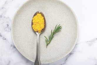 Yuzu caviar is pearly, on a spoon, top view, light background, no people.