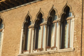 Windows of an old house on 'Campo santa margherita' town square in Venice on a sunny day in winter,