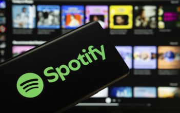 Dhaka, Bangladesh - 18 March 2025: The logo of the spotify is displayed on a smartphone screen, and