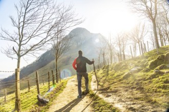 A man climbing Mount Ernio or Hernio in Gipuzkoa at sunset, Basque Country