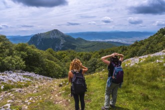 Mount Aizkorri 1523 meters, the highest in Guipuzcoa. Basque Country. Two friends on the trail to