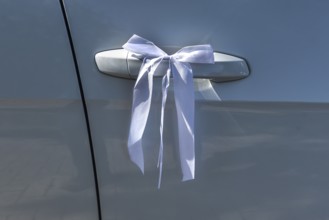 White ribbon on the door handle of a wedding car, Mecklenburg-Vorpommern, Germany