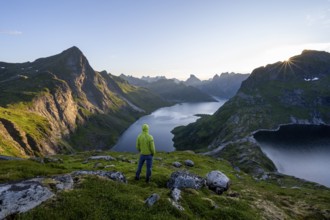 Mountaineer looking over mountain landscape with pointed mountain peaks and fjord Forsfjorden with
