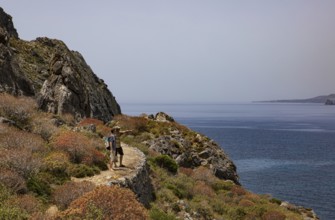 Hikers on the Sarella peninsula near Plakias, south coast, Crete, Greece