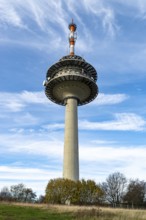 The telecommunications tower on the Köterberg rises into a blue sky with scattered clouds,