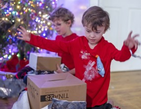 Denver, Colorado - Hendrix Hjermstad, 6, (right) and his brother Adam Hjermstad Jr., 10, open
