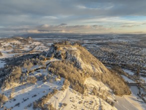 Aerial view of the snow-covered Hegau volcano Hohentwiel with Germany's largest castle ruins on a