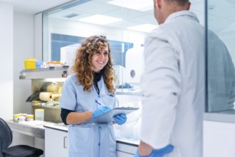 Scientists writing data working in a research laboratory in an hospital