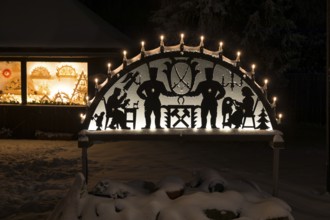 Snow-covered, illuminated arch of lights in Oberbärenburg, Altenberg, Saxony, Germany