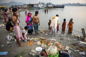 People offer prayers on the bank of Brahmaputra river on Ashoka Ashtami Festival during Chaitra