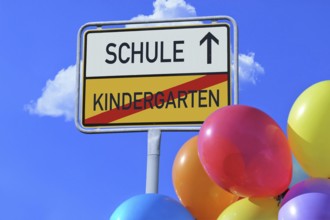 (Photomontage) Town exit sign with the lettering KINDERGARTEN/SCHULE