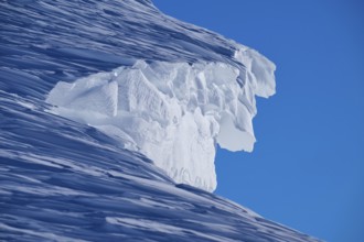 Close-up of a snow cornice under a clear blue sky, Gemmi Pass, Plattenhörner, Leukerbad, Leuk,