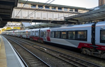 Carriages of long inter-city train at railway station platform, Ipswich, Suffolk, England, UK