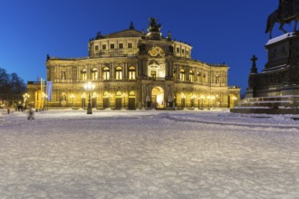 Illuminated Semper Opera House and Theatre Square with snow at dusk, Old Town of Dresden, Saxony,