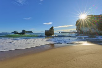Sunbeams breaking over a rocky beach, Cathedral Cove, Coromandel, Canterbury, North Island, New