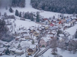 Snow-covered settlement with colourful houses on the edge of the forest, Enzklösterle, Calw
