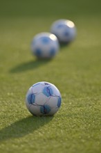 Adidas Derbystar match balls lying on grass, backlight, Voith-Arena, Heidenheim, Baden-Württemberg,