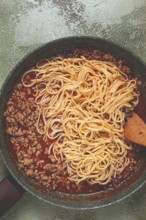Spaghetti Bolognese, top view, in a frying pan, close-up, without people, homemade