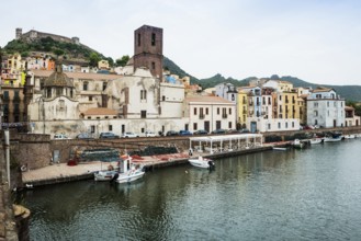 Colourful houses and fishing boats on the river Terno, Bosa, district of Oristano, Sardinia, Italy