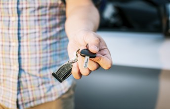 Driver's hands showing the car keys, Close-up of male driver hands showing the keys, Vehicle rental