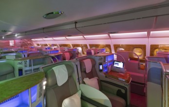 Modern airplane interiors, luxury first class and business class seats with entertainment area .