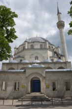 View of a mosque with a large dome and a high minaret surrounded by trees, Tombul Mosque, Sherif