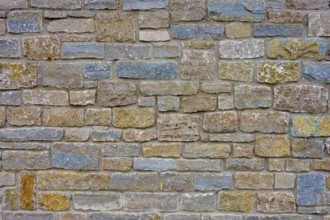 Natural stone wall with blue, grey discolouration and varied structure, Würzburg, Bavaria, Germany