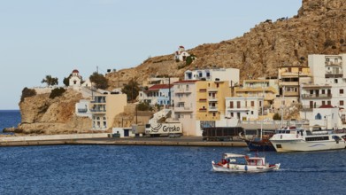 A coast with boats, colourful houses on rocks, surrounded by deep blue sea and a harbour, fishing