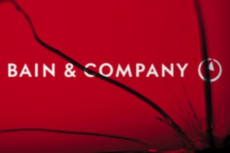 Bain & Company logo is visible on the broken glass. Bain & Company is an American management