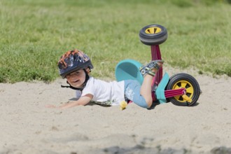 A boy in a helmet fell on his bicycle. Pobierowo, Poland