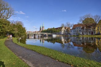 River Trave at high water, general architecture, footpath, pedestrian bridge, trees and bushes,