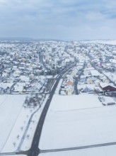 Aerial view of a small snow-covered village surrounded by fields, Deckenpfronn, Böblingen district,