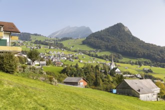 View of Amden with church and Chapf, in the background the Churfirsten mountain range with the