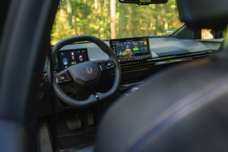 Modern car interior with digital dashboard and touchscreen in the forest, Deer E- Carsharing, Calw,